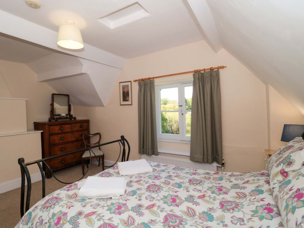 A bedroom with a bed and a dresser at The West Wing