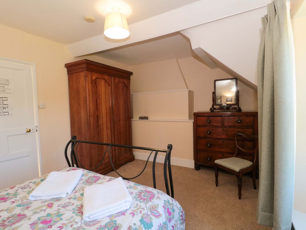 A bedroom with a bed, wardrobe, and chest of drawers at The West Wing