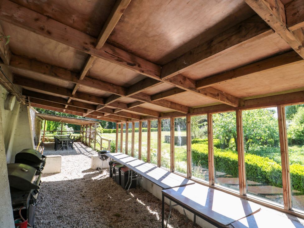 An outdoor area with tables and barbecues at The West Wing 