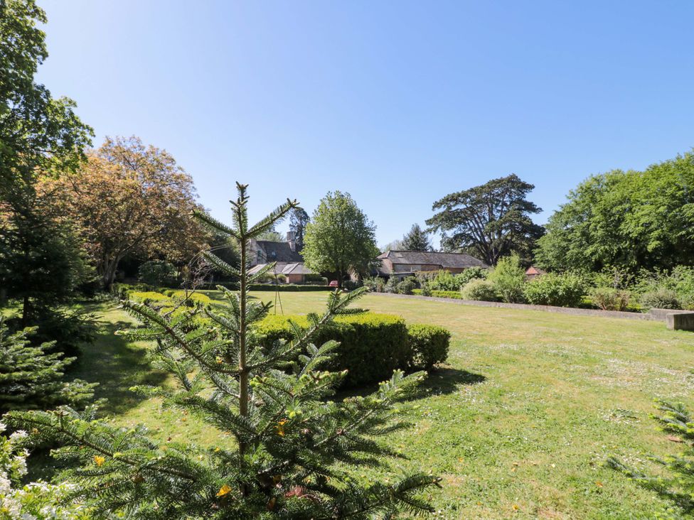 A garden with trees and grass at The West Wing