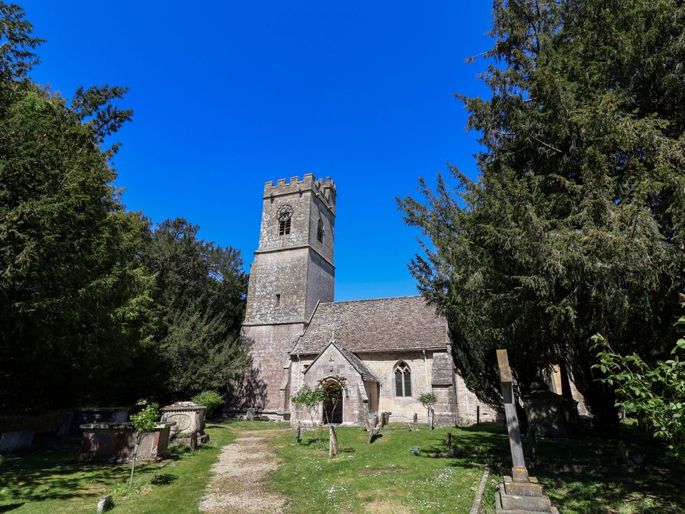 A church with a tower and grave stones in the outdoor area