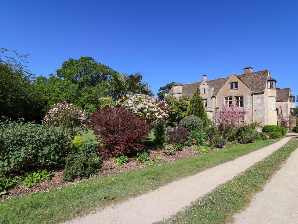 A house with a garden and pathway at The West Wing
