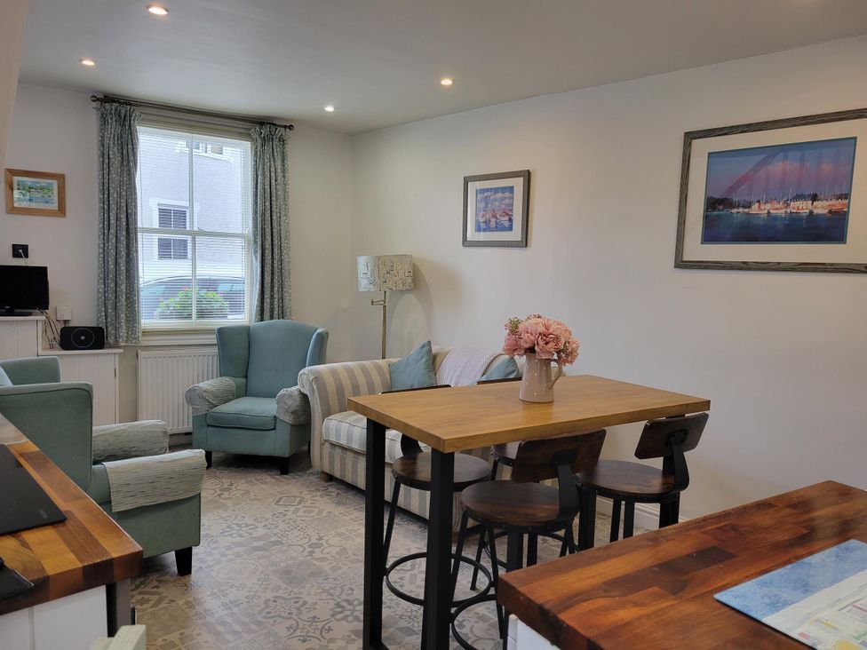 A living room with a sofa and armchairs at Millgate Cottage in Conwy
