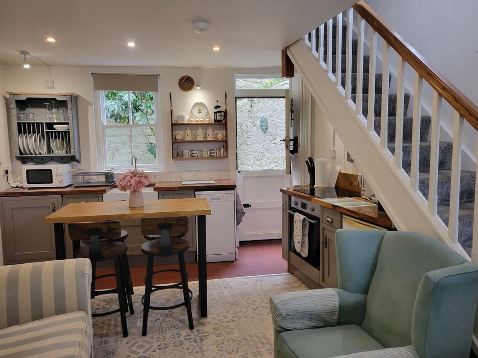 A kitchen with a table and chairs at Millgate Cottage in Conwy