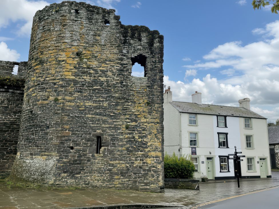 A stone tower and house on street at Millgate Cottage Conwy