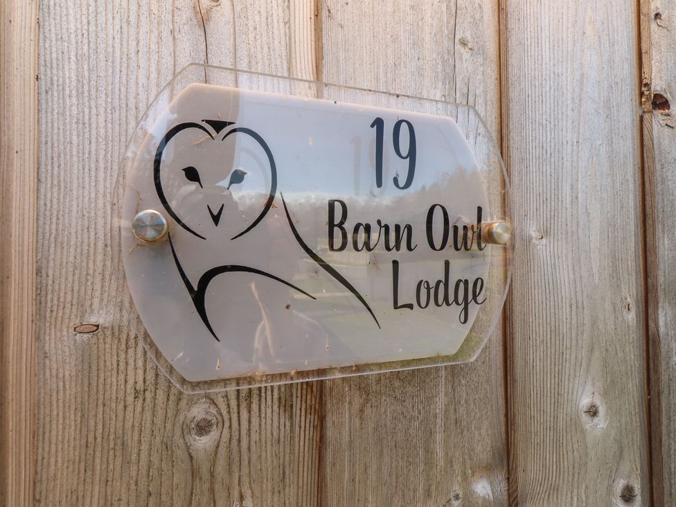 A sign with the number 19 and Barn Owl Lodge outdoors at Barn Owl Lodge in Otterburn