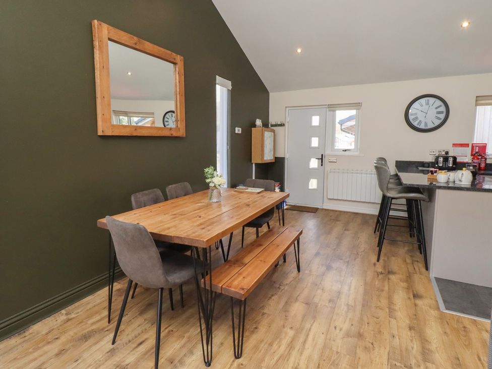A dining room with a table and chairs at Barn Owl in Otterburn