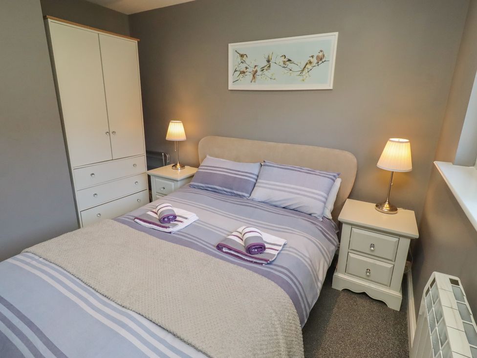 A bedroom with a bed and furniture at Barn Owl in Otterburn