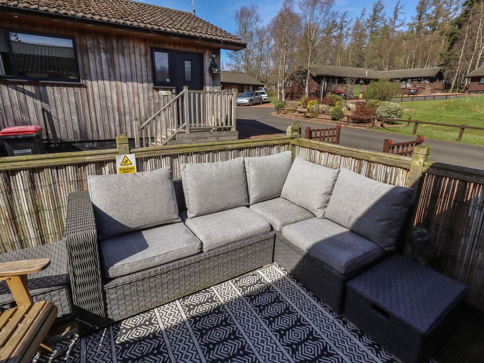 An outdoor seating area with a sofa and coffee table at Barn Owl in Otterburn
