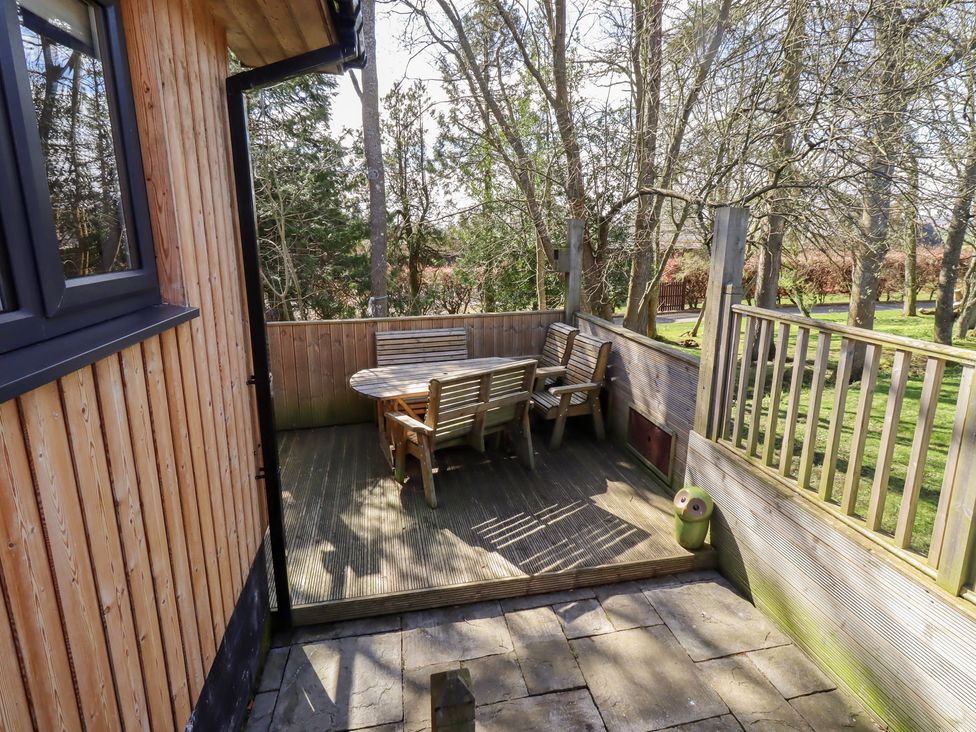 An outdoor patio with a table and chairs at Barn Owl in Otterburn