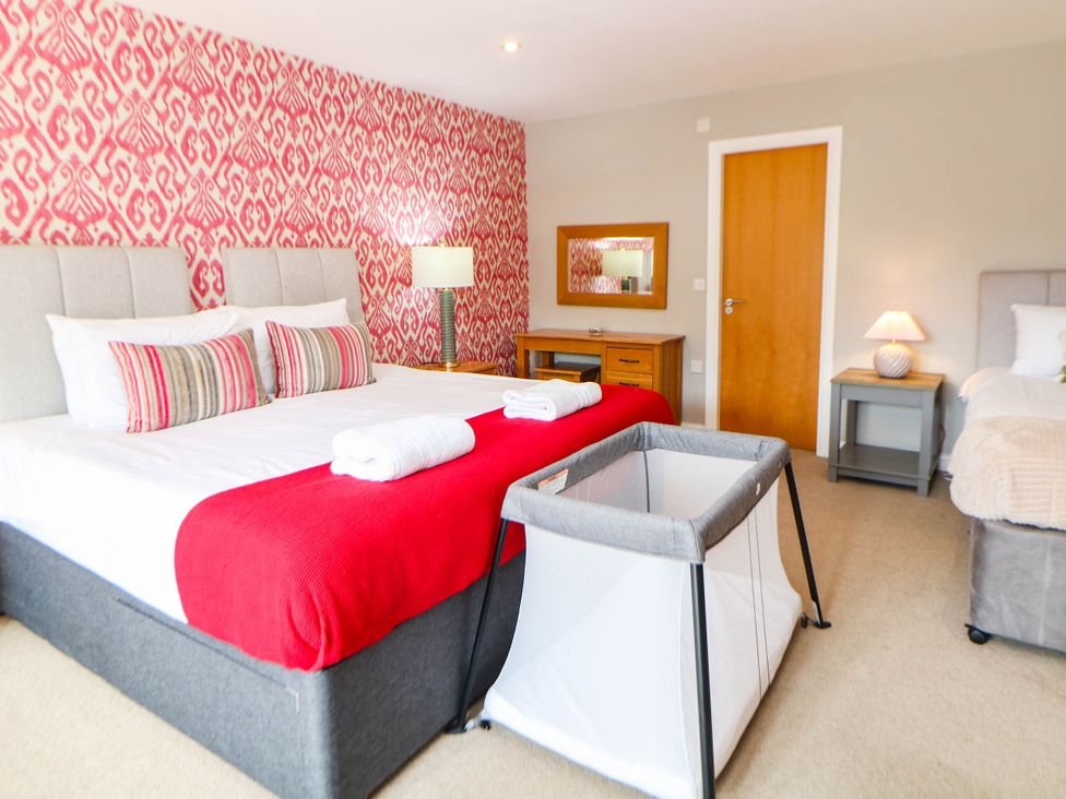 A bedroom with a bed and dressing table at Hassop in Matlock