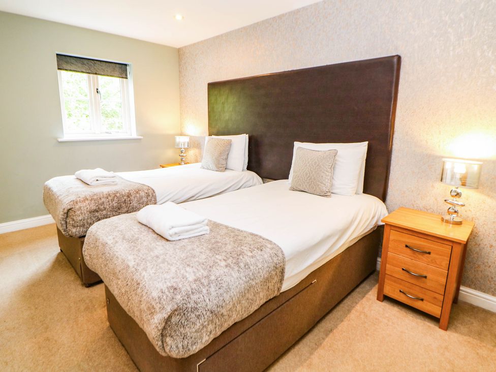 A bedroom with two single beds at Hassop in Matlock
