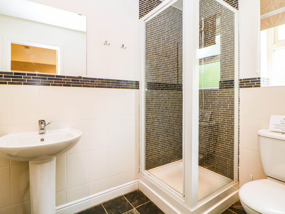 A bathroom with a sink, shower, and toilet at Hassop in Matlock