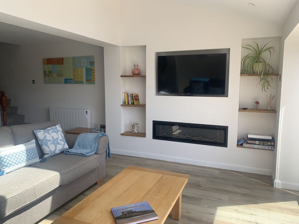 A living room with a sofa and coffee table at The Nest in Beadnell
