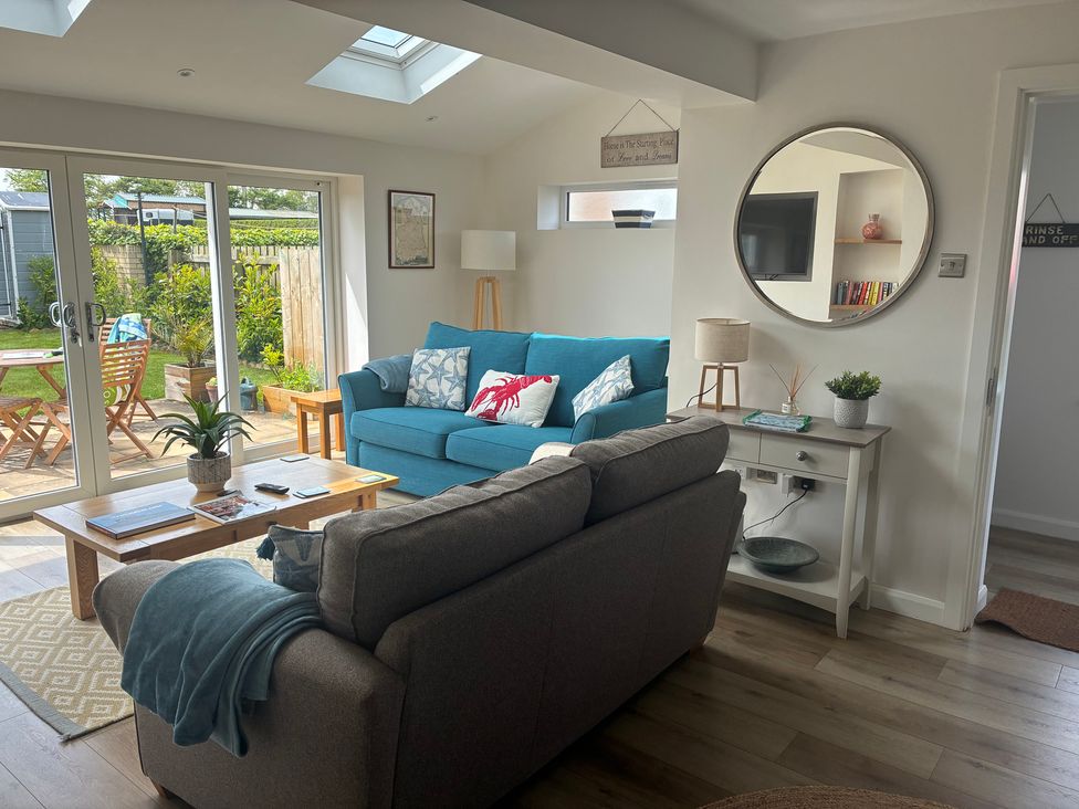 A living room with a sofa and coffee table at The Nest in Beadnell