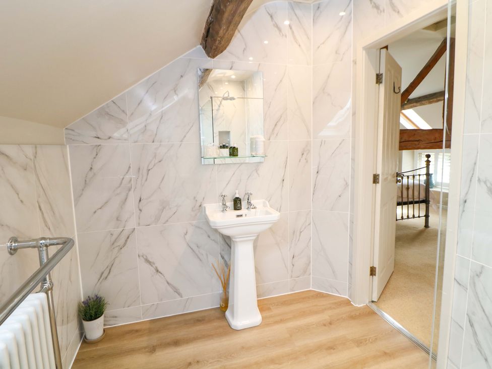 A bathroom with a sink and mirror at Brookhouse in Castleton, Peak District
