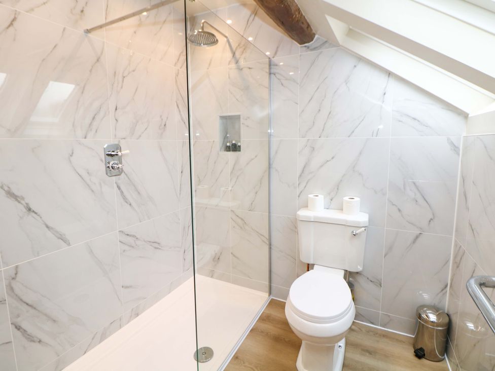 A bathroom with a shower and toilet at Brookhouse in Castleton, Peak District