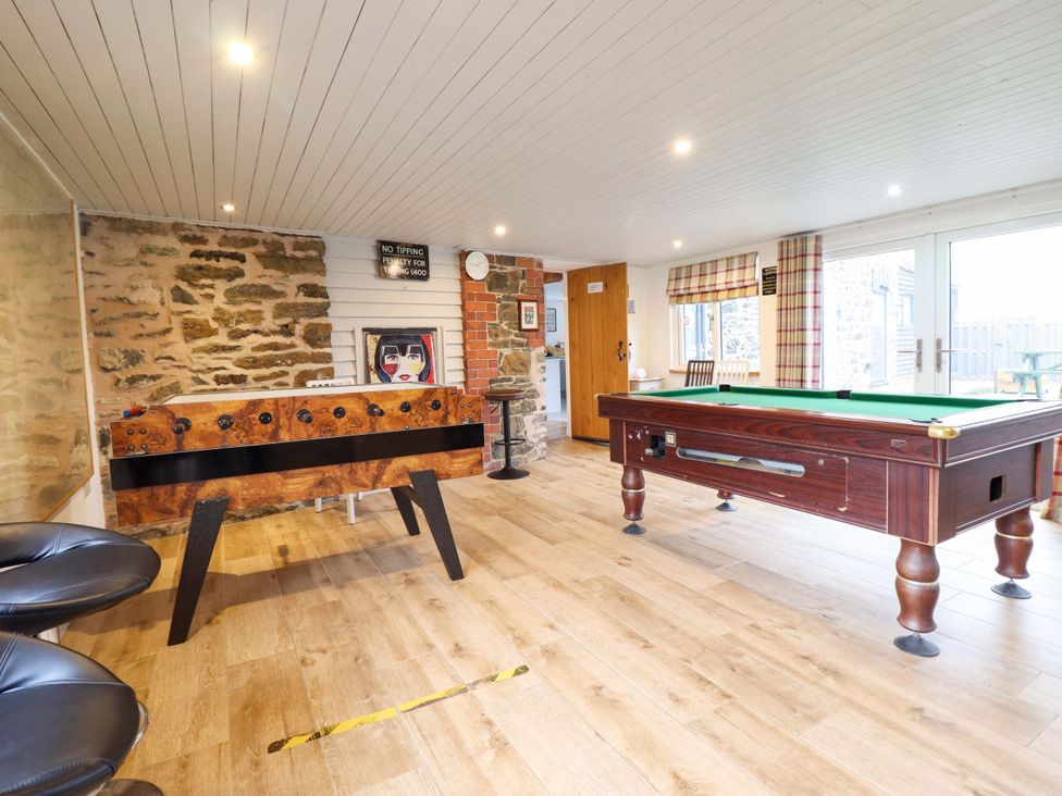 A snug with a foosball table and pool table at Bwthyn Y Bugail (Shepherd's Cottage) Pedairffordd near Llanrhaeadr-Ym-Mochnant