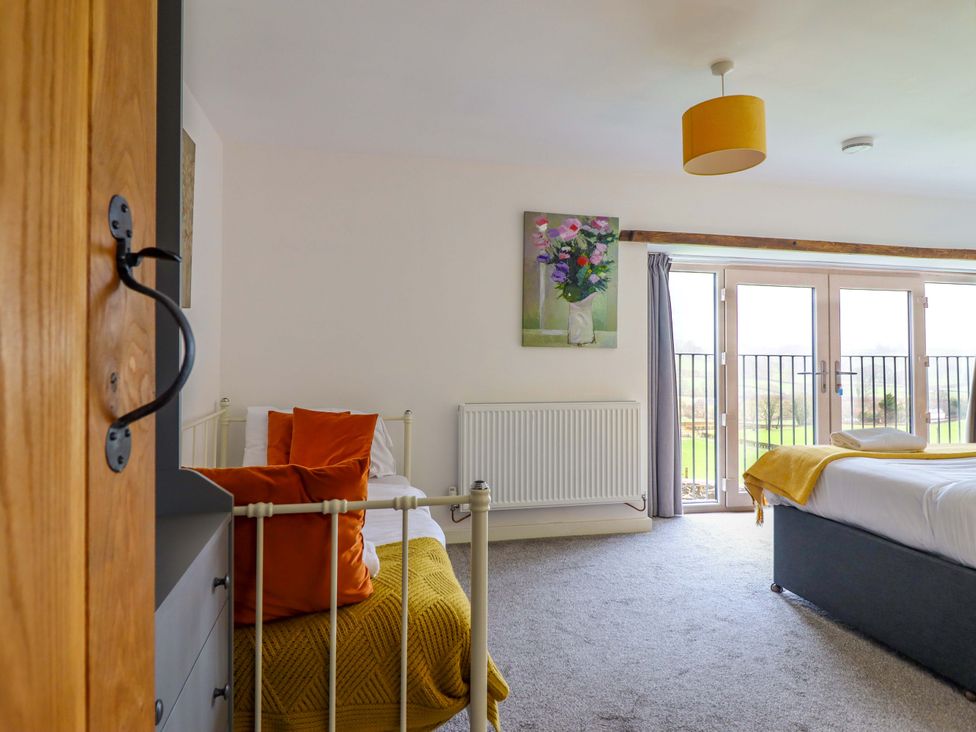 A bedroom with beds and a painting at Bwthyn Y Bugail (Shepherd's Cottage) Pedairffordd near Llanrhaeadr-Ym-Mochnant