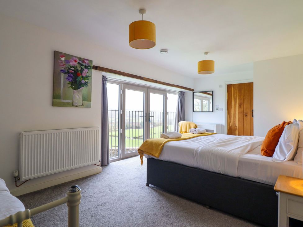 A bedroom with a bed and a window at Bwthyn Y Bugail (Shepherd's Cottage) Pedairffordd near Llanrhaeadr-Ym-Mochnant