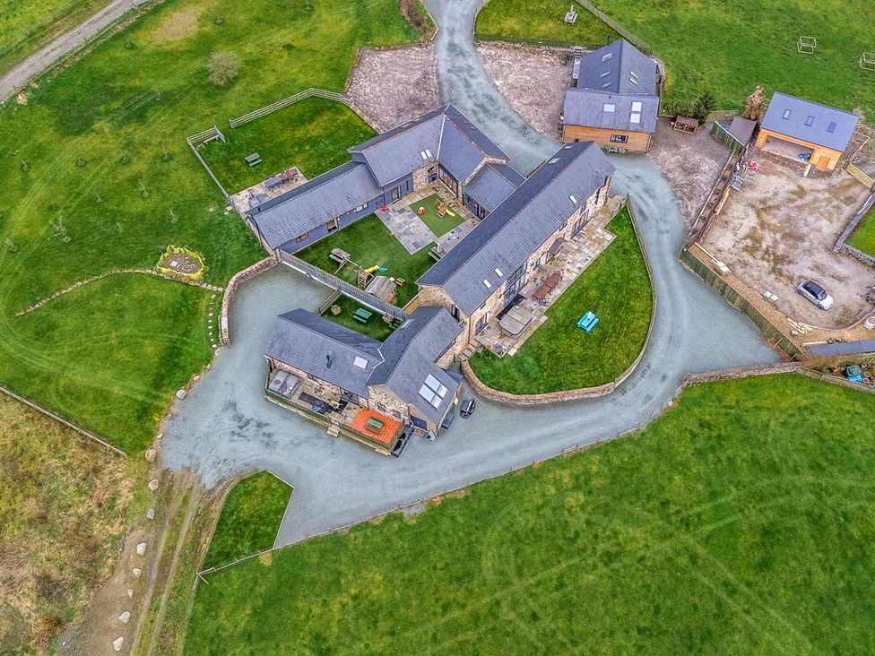 An aerial view of a property with multiple buildings and greenery at Bwthyn Y Bugail (Shepherd's Cottage) Pedairffordd near Llanrhaeadr-Ym-Mochnant