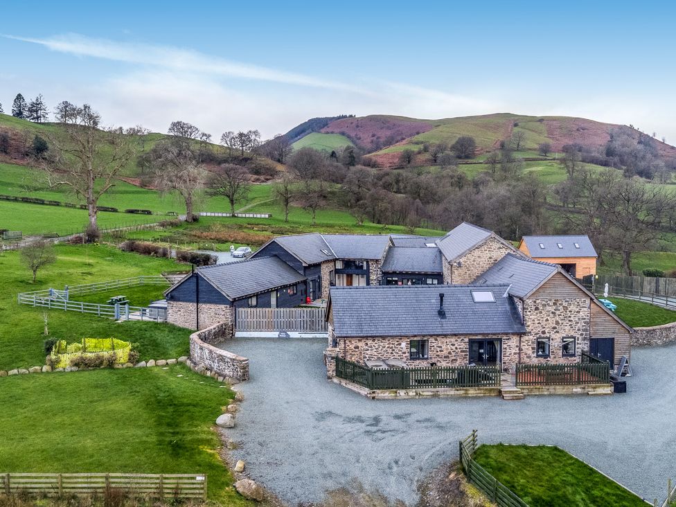 An overview of a house surrounded by gardens and fields at Y Beudy (The Dairy) Pedairffordd near Llanrhaeadr-Ym-Mochnant