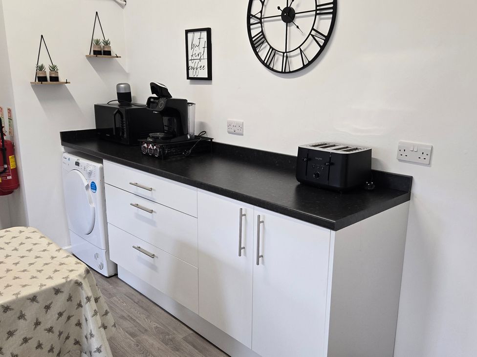 A kitchen with appliances on countertop at Sunnymeade, Buxton, Norfolk