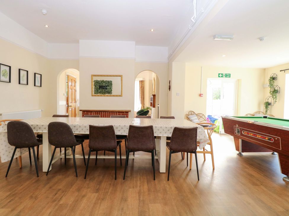 A dining room with a table and chairs and a pool table at Sunnymeade in Buxton, Norfolk