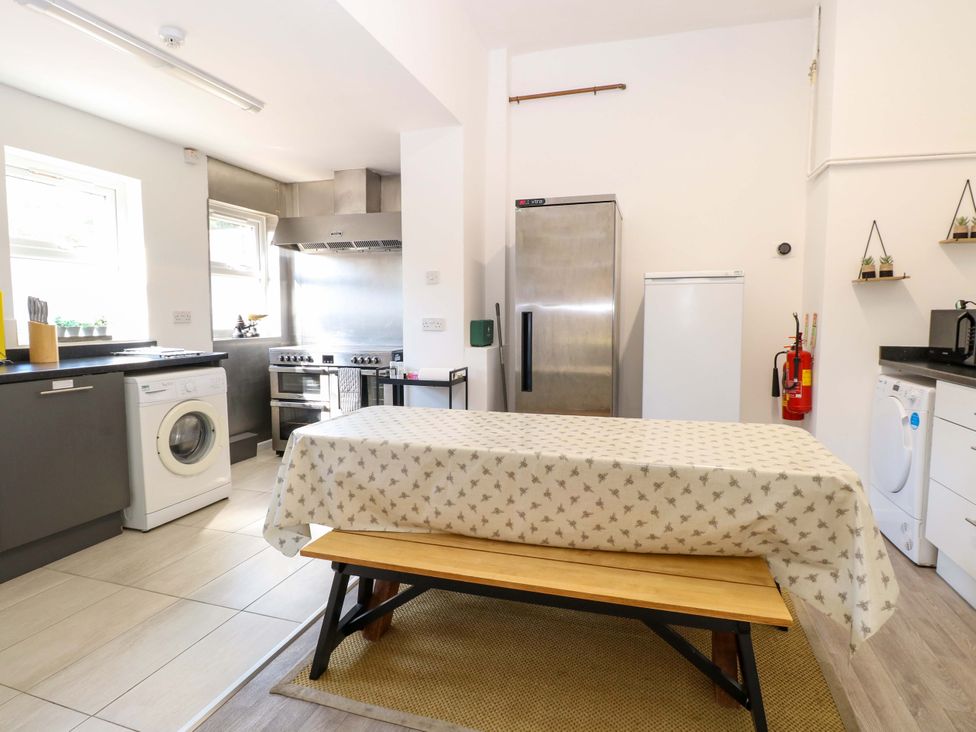 A kitchen featuring a washing machine and refrigerator at Sunnymeade, Buxton, Norfolk