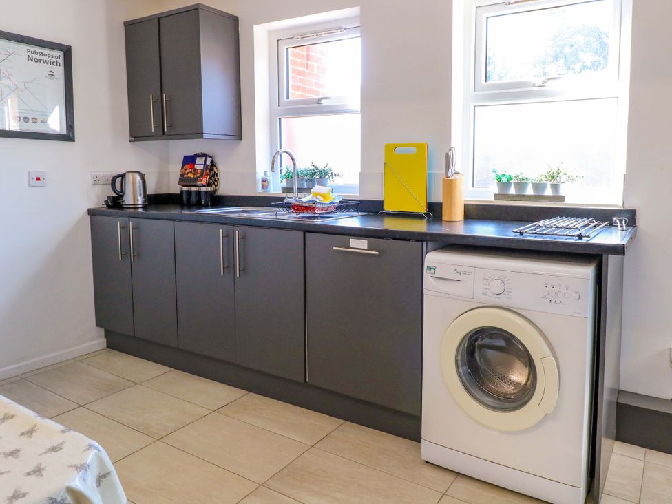 A kitchen with cabinets and appliances at Sunnymeade in Buxton, Norfolk