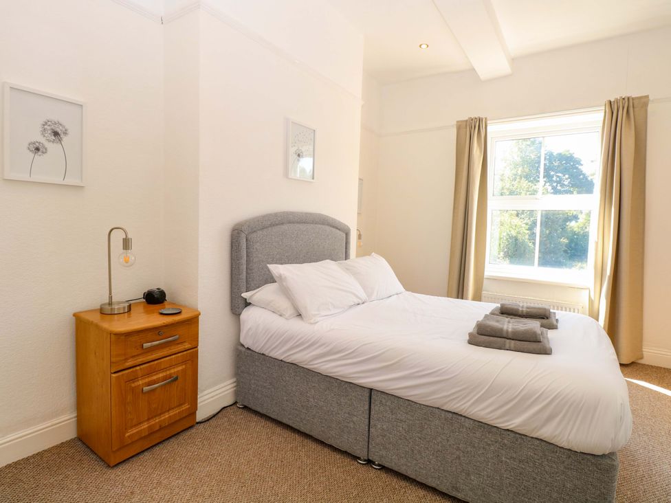 A bedroom with a bed and nightstand at Sunnymeade Buxton, Norfolk