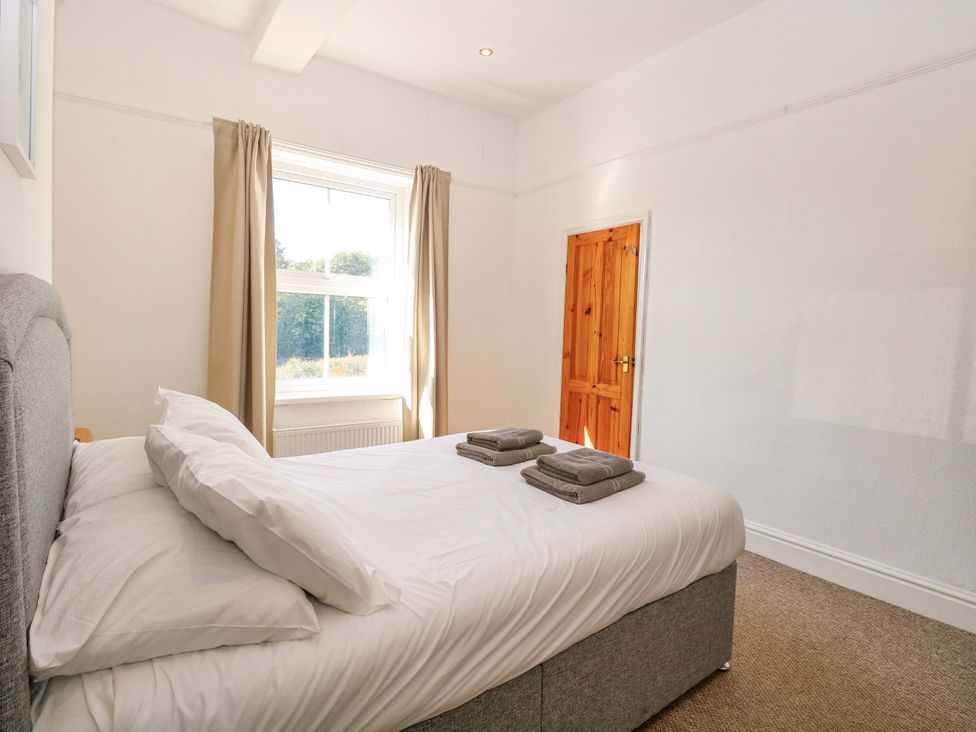 A bedroom with a bed and towels on top at Sunnymeade in Buxton, Norfolk