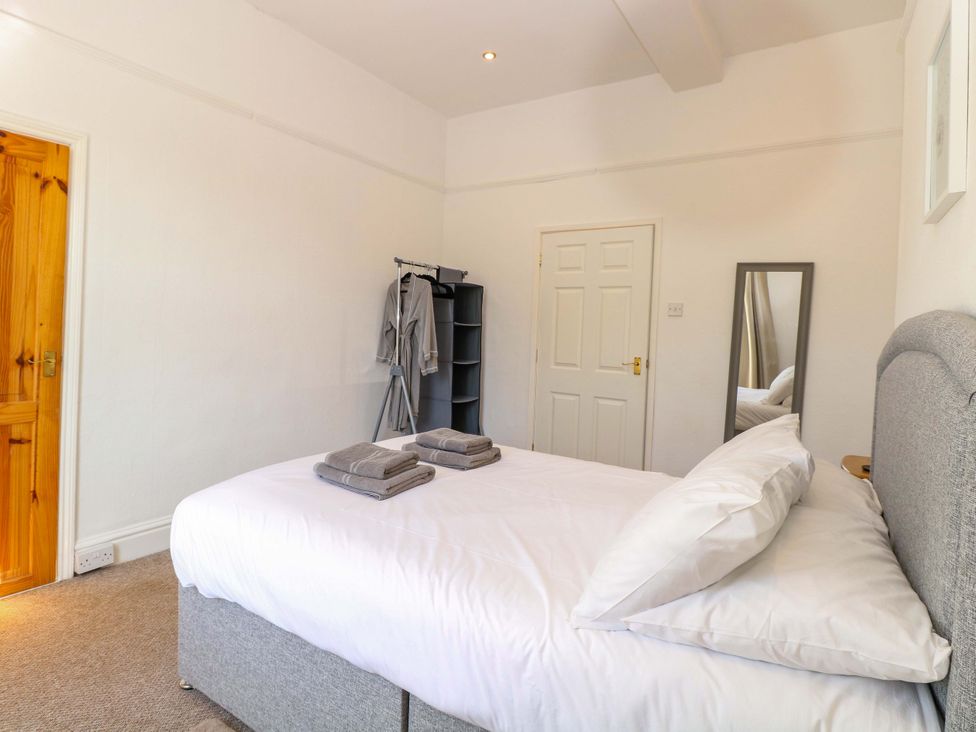 A bedroom with a bed and towels on top at Sunnymeade in Buxton, Norfolk