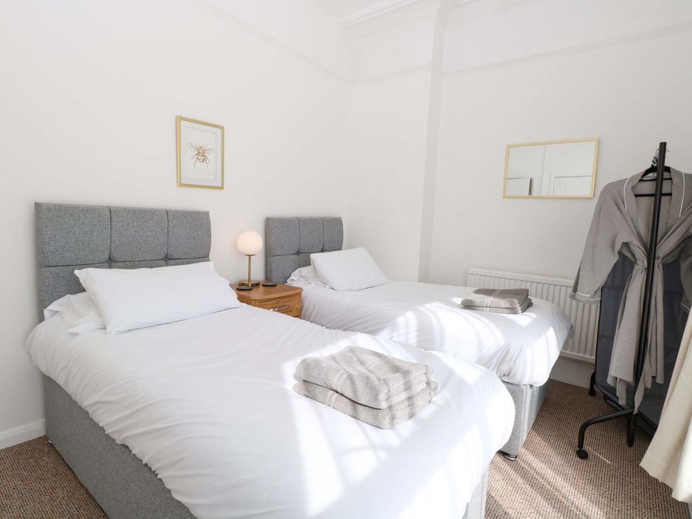 A bedroom with two beds and a nightstand at Sunnymeade Buxton, Norfolk