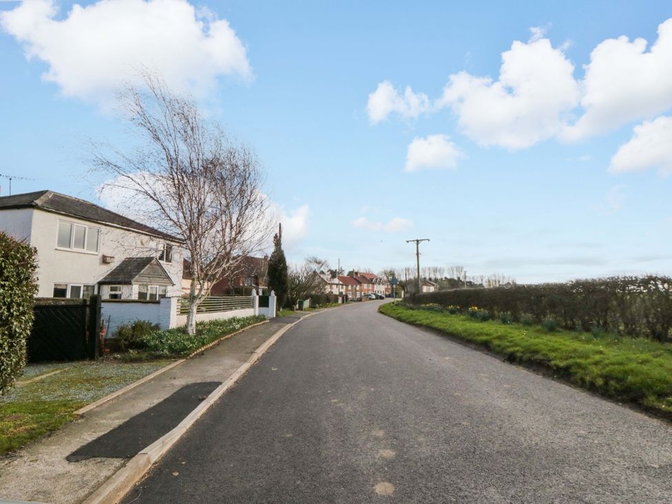 A road with houses and trees at Kingfisher Corner Little Kelk near Bridlington