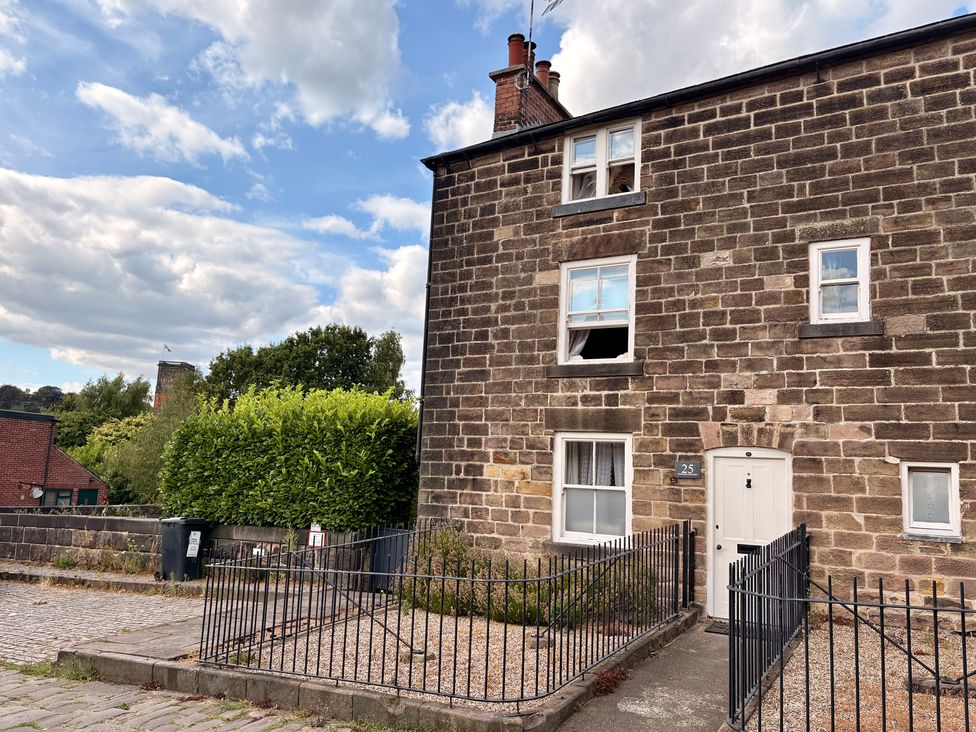 A house with stone walls and a front door at Coupling Cottage in Belper