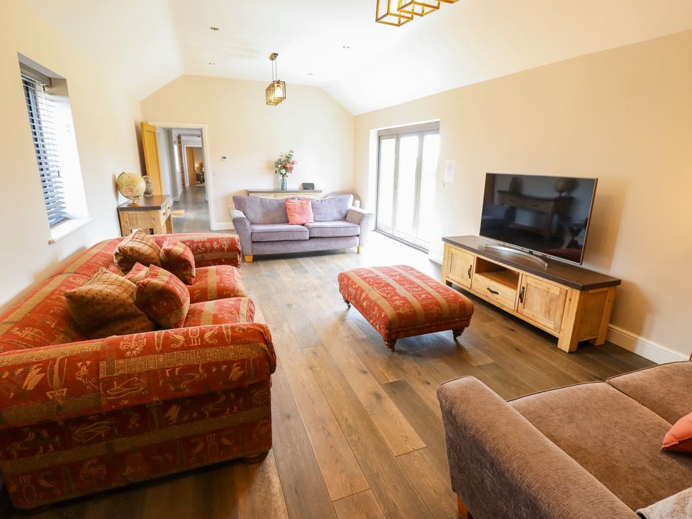 A living room with sofas and a television at The Stables in Wrangle near Old Leake