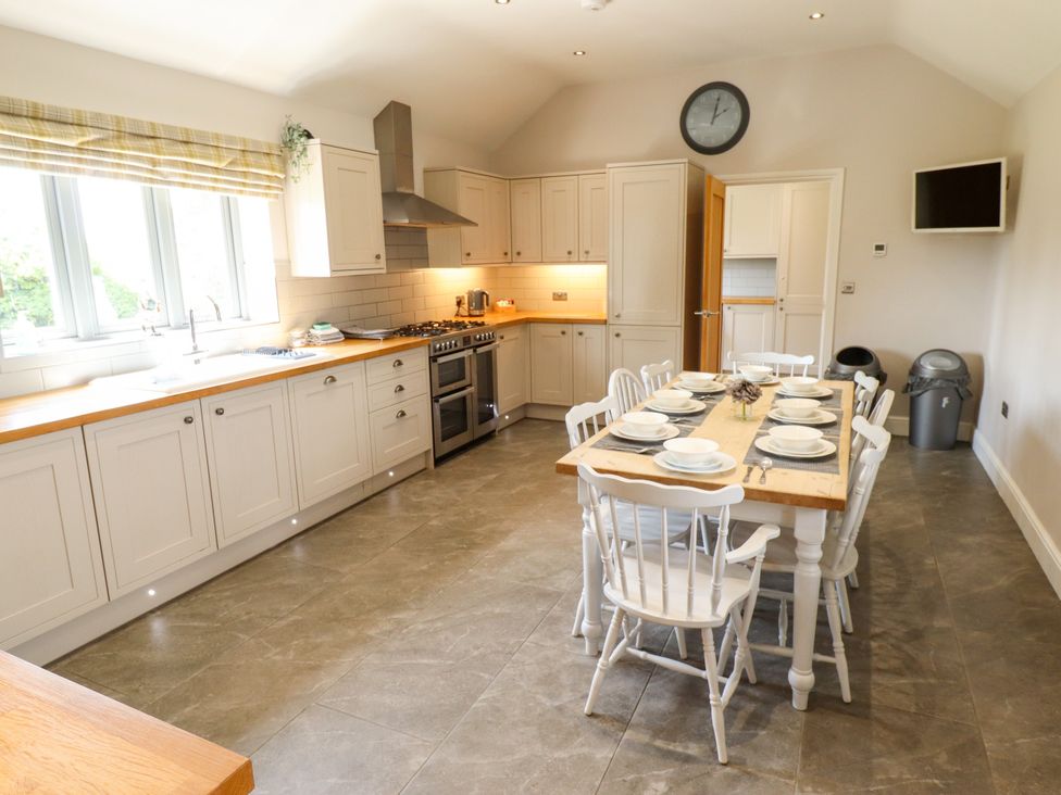 A kitchen with a dining table and chairs at The Stables in Wrangle near Old Leake