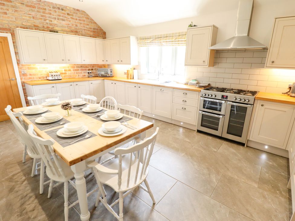 A kitchen with a dining table and chairs at The Stables in Wrangle near Old Leake