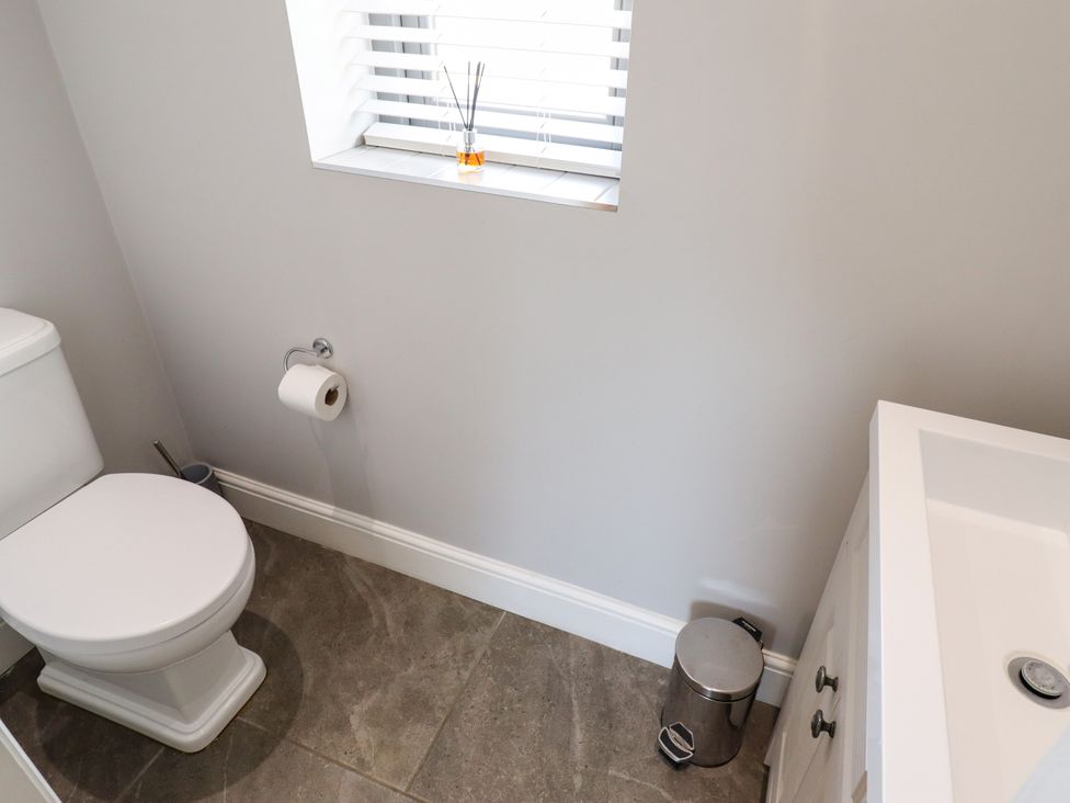 A bathroom with a toilet and sink at The Stables in Wrangle near Old Leake