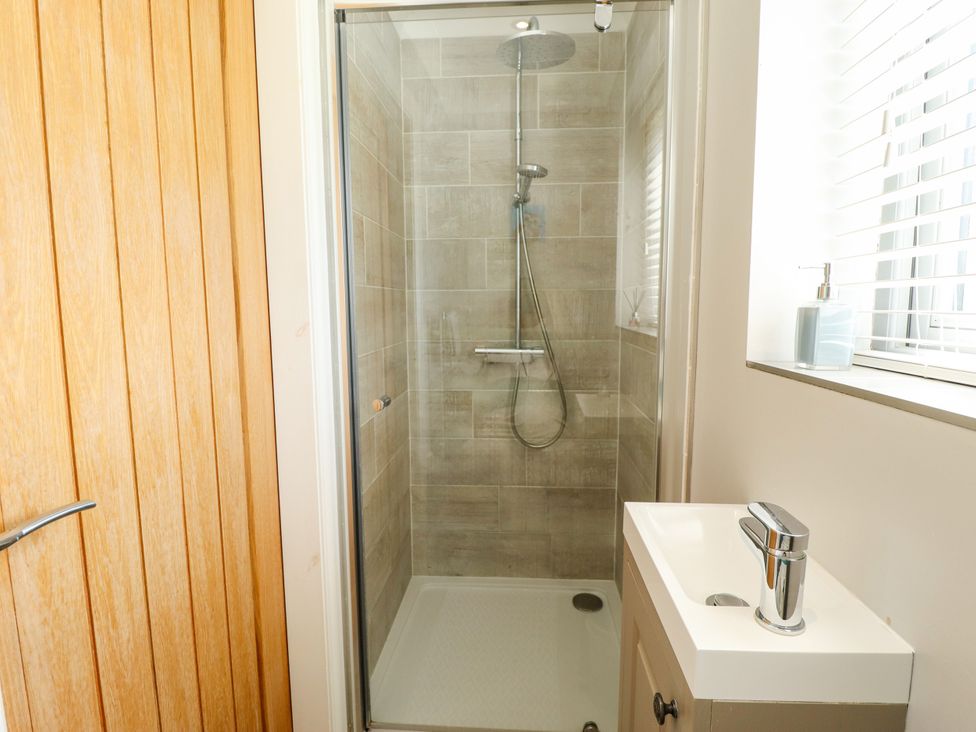 A bathroom with a shower and sink at The Stables in Wrangle near Old Leake