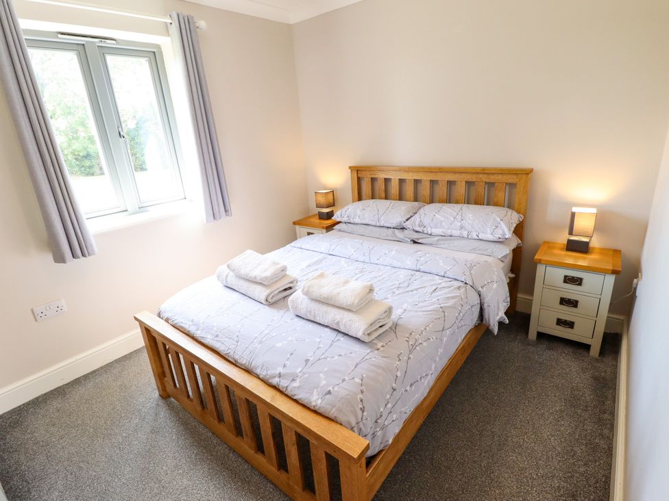 A bedroom with a bed and nightstands at The Stables in Wrangle near Old Leake