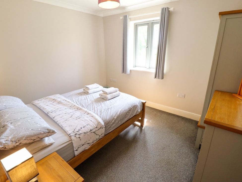 A bedroom with a bed and wardrobe at The Stables Wrangle near Old Leake
