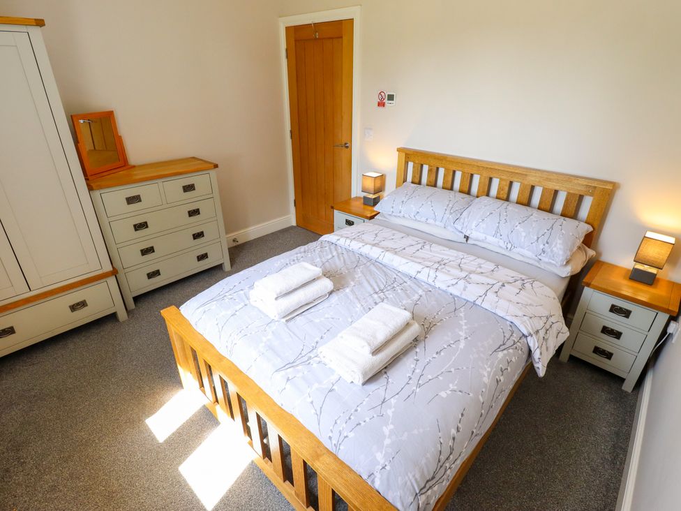 A bedroom with a bed and furniture at The Stables in Wrangle near Old Leake
