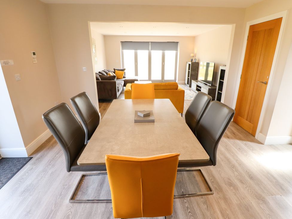 A dining room with a table and chairs at Acacia Barn in Wrangle near Friskney