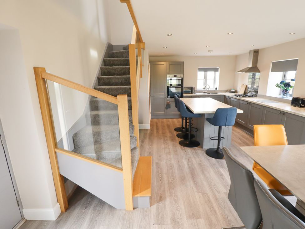 A kitchen with stairs leading to upper level at Acacia Barn Wrangle near Friskney
