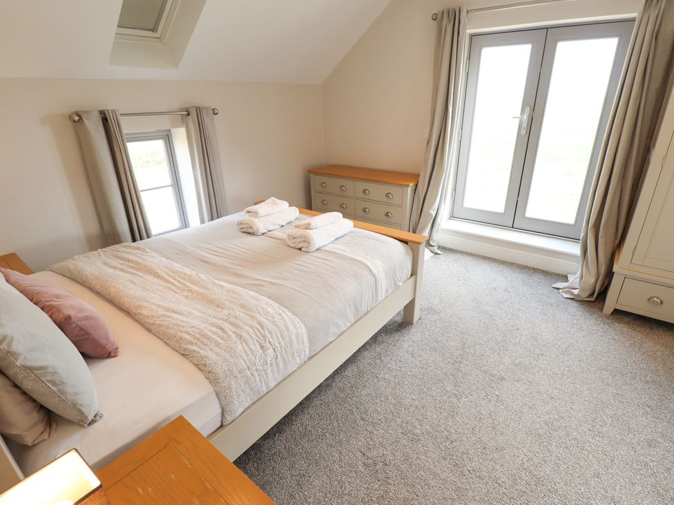 A bedroom with a bed and dresser at Acacia Barn near Wrangle Friskney