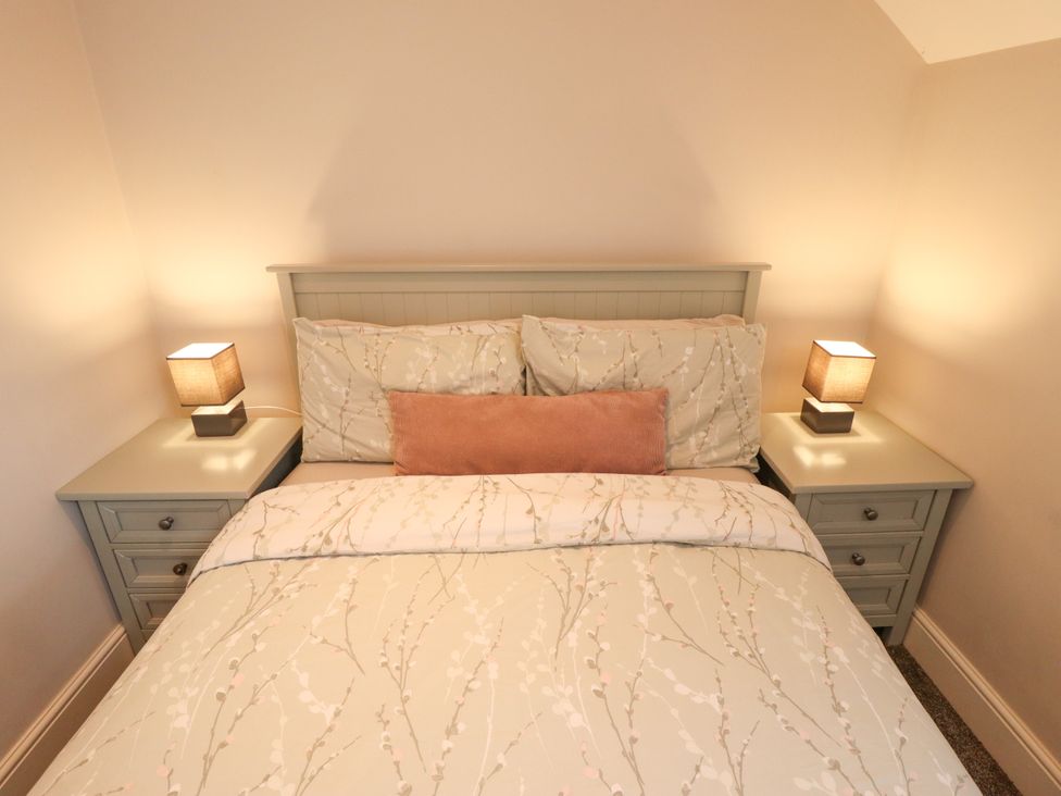 A bedroom with a bed and bedside tables at Acacia Barn in Wrangle near Friskney