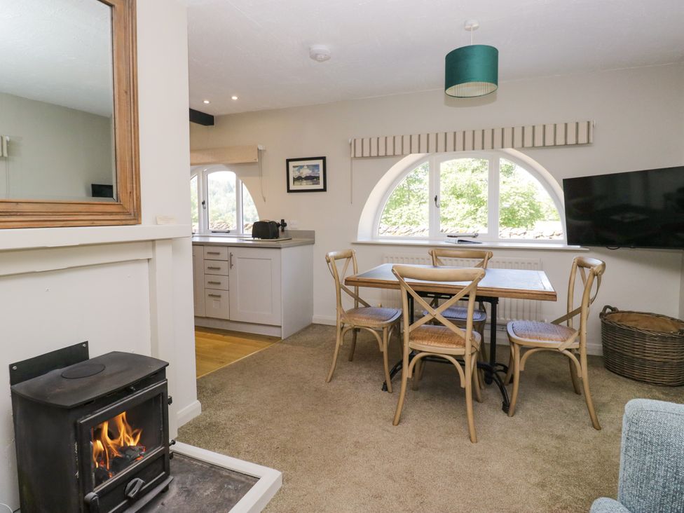 A kitchen dining area with a table and chairs at Windermere at the Graythwaite Estate near Hawkshead