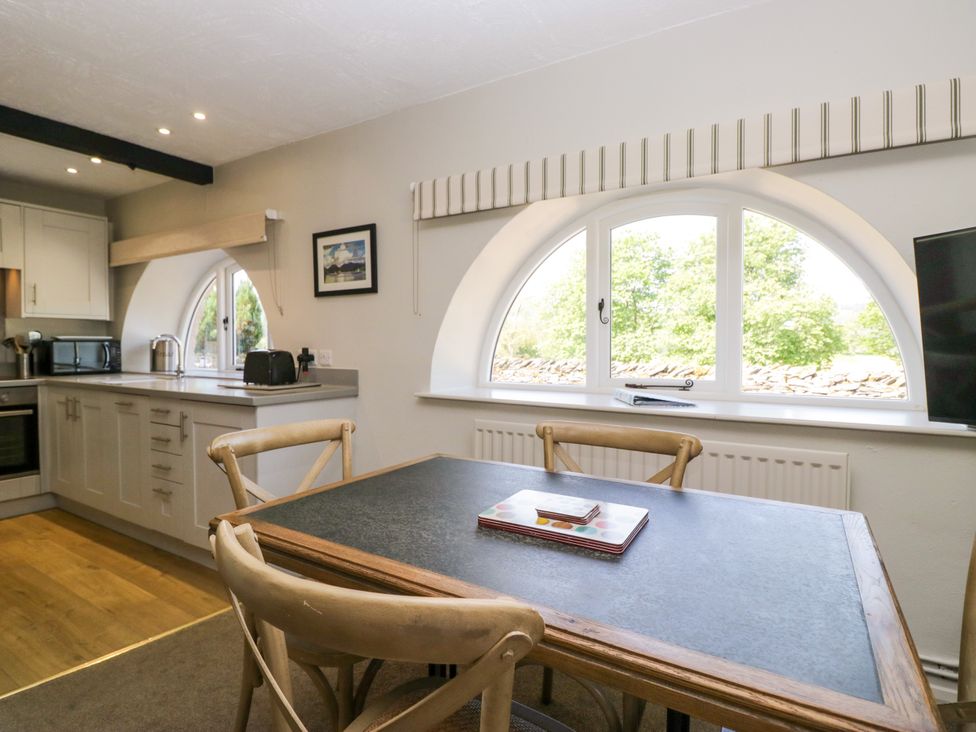 A kitchen with a table and chairs at Windermere at the Graythwaite Estate near Hawkshead